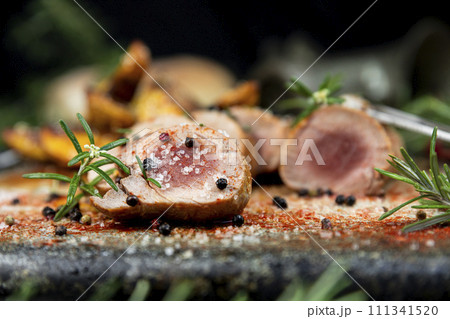 Pork tenderloin chops served with potatoes and rosemary Pork tenderloin chops served with potatoes and rosemary 111341520