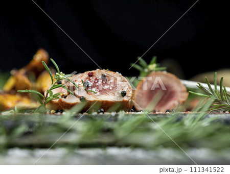 Pork tenderloin chops served with potatoes and rosemary 111341522