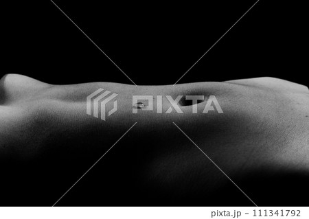 Beautiful female body in honey on dark background, studio 111341792