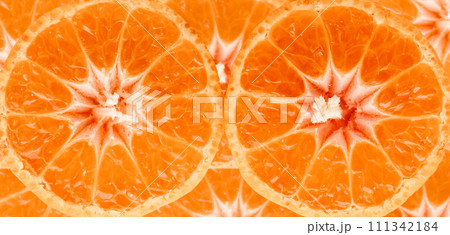 Tangerine slices close-up photo. Orange food background of ripe clementines. 111342184