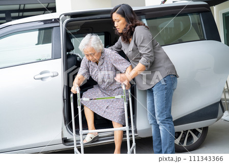Asian senior woman patient walk with walker prepare get to her car, healthy strong medical concept. Asian senior woman patient walk with walker prepare get to her car, healthy strong medical concept. 111343366