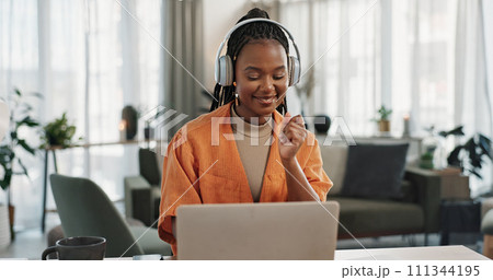 Laptop, dancing and young woman in the living room listening to music, album or radio of apartment. Technology, smile and young African female person streaming a song on a computer in lounge at home. 111344195