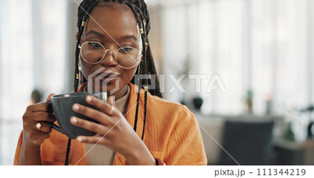 Calm, cup of coffee and black woman in the living room of her modern apartment in the morning. Peaceful, mug and young African female person drinking caffeine or latte in her home on weekend. Calm, cup of coffee and black woman in the living room of her modern apartment in the morning. Peaceful, mug and young African female person drinking caffeine or latte in her home on weekend. 111344219
