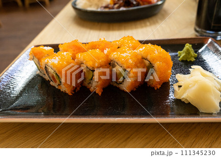 Maki Sushi, California Rolls with Cucumber, Avocado, Raw Fish and Red Tobiko Caviar, Makizushi Maki Sushi, California Rolls with Cucumber, Avocado, Raw Fish and Red Tobiko Caviar, Makizushi 111345230
