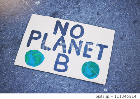 Protest poster, billboard or climate change sign on city street for planet earth, globe or world sustainability. Zoom on abstract cardboard banner in future global warming or eco environment security Protest poster, billboard or climate change sign on city street for planet earth, globe or world sustainability. Zoom on abstract cardboard banner in future global warming or eco environment security 111345814