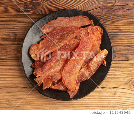 Meat Jerky Isolated, Dry Salted Chicken Slices, Small Pieces of Dehydrated Beef, Beer Snacks, Dried Pork Meat Jerky Isolated, Dry Salted Chicken Slices, Small Pieces of Dehydrated Beef, Beer Snacks, Dried Pork 111345946
