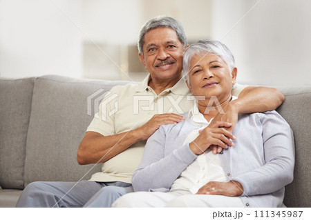 Portrait of senior couple relax with love on a home living room sofa happy, smile and enjoy peace, freedom and calm lifestyle. Romantic, elderly man and woman living retirement life together bonding 111345987