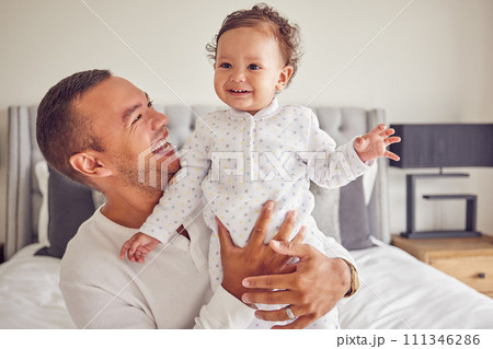 A happy dad and baby with smile on the bed at home, having fun and laughing together. Portrait of man bonding, smiling and playing with kid in bedroom. Family, love and care from father A happy dad and baby with smile on the bed at home, having fun and laughing together. Portrait of man bonding, smiling and playing with kid in bedroom. Family, love and care from father 111346286