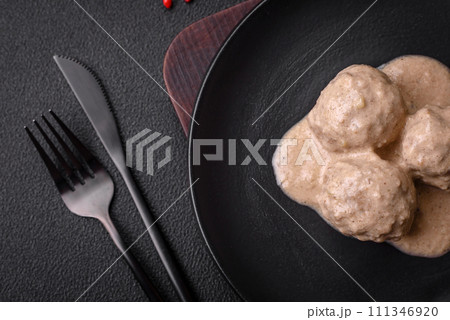 Delicious meatballs from minced chicken or turkey with sour cream sauce Delicious meatballs from minced chicken or turkey with sour cream sauce 111346920
