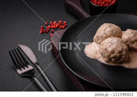 Delicious meatballs from minced chicken or turkey with sour cream sauce Delicious meatballs from minced chicken or turkey with sour cream sauce 111346922