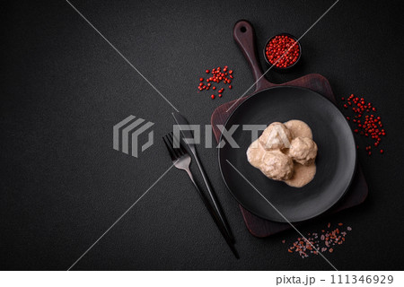 Delicious meatballs from minced chicken or turkey with sour cream sauce Delicious meatballs from minced chicken or turkey with sour cream sauce 111346929