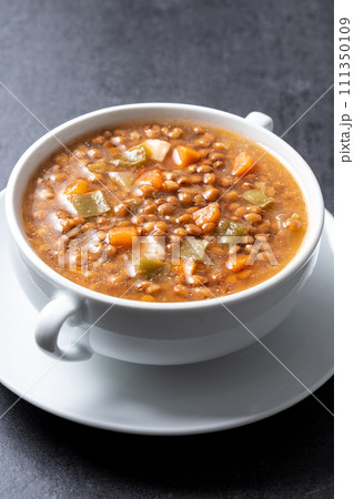 Lentil soup with vegetables in bowl isolated on white background Lentil soup with vegetables in bowl isolated on white background 111350109