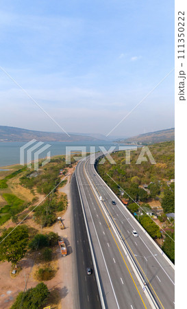 The M6 motorway Expressway Nakhon Ratchasima Province - Bang Pa-in. Lam Ta Khong River and Mountain. Drone shot of scenic landscape rural place traffic. Nakhon Ratchasima Thailand. Motorway Korat The M6 motorway Expressway Nakhon Ratchasima Province - Bang Pa-in. Lam Ta Khong River and Mountain. Drone shot of scenic landscape rural place traffic. Nakhon Ratchasima Thailand. Motorway Korat 111350222