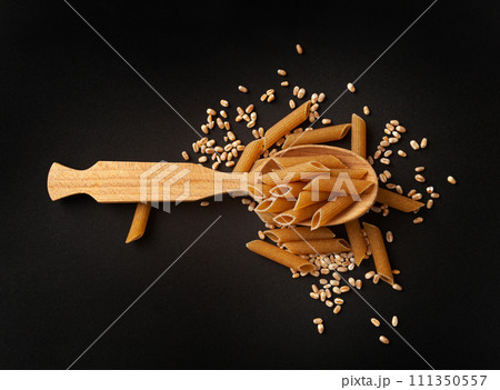 Raw Brown Pasta, Wholegrain Penne, Dry Whole Grain Noodle, Raw Spelt Macaroni, Healthy Italy Food Raw Brown Pasta, Wholegrain Penne, Dry Whole Grain Noodle, Raw Spelt Macaroni, Healthy Italy Food 111350557