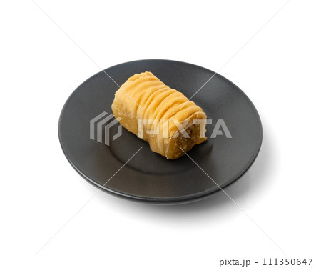 Rolled Baklava Isolated, Ramadan Dessert Roll on Restaurant Plate, Eastern Sweet Pastries Rolled Baklava Isolated, Ramadan Dessert Roll on Restaurant Plate, Eastern Sweet Pastries 111350647