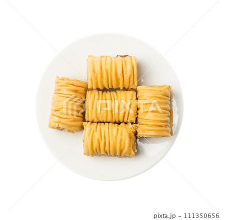 Rolled Baklava Isolated, Ramadan Dessert Roll on Restaurant Plate, Eastern Sweet Pastries Rolled Baklava Isolated, Ramadan Dessert Roll on Restaurant Plate, Eastern Sweet Pastries 111350656