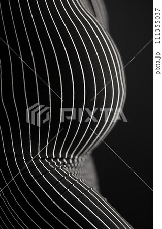 Curvy pregnant woman body in black and white striped pattern dress. 111355037