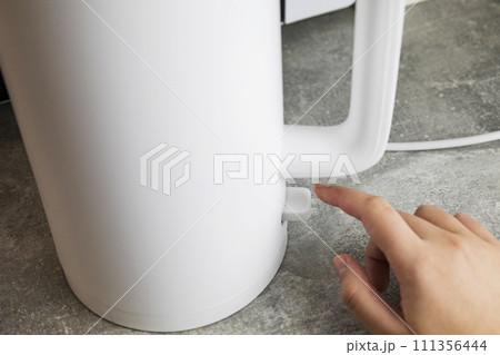 Includes an electric kettle for boiling water. Energy saving concept, expensive electricity Includes an electric kettle for boiling water. Energy saving concept, expensive electricity 111356444