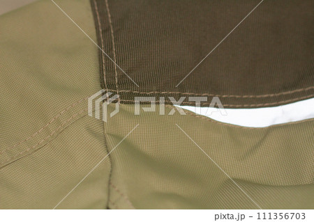 Khaki workwear protective clothing reflector inserts close-up details. 111356703