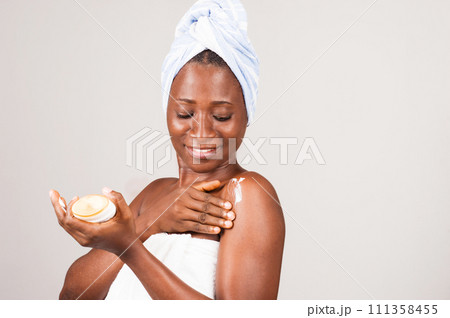 beautiful african woman putting on ointment. 111358455