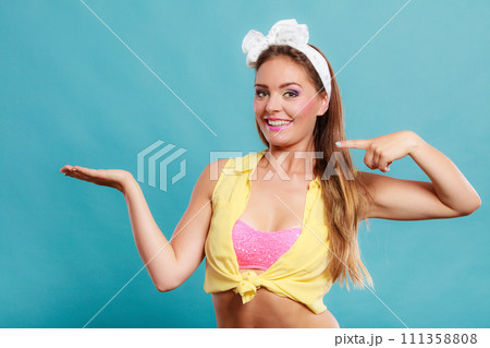 Happy pin up girl with empty hand for copy space. Happy pin up girl with empty hand for copy space. 111358808