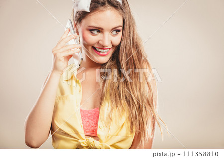 Retro pin up girl talking on mobile phone Retro pin up girl talking on mobile phone 111358810