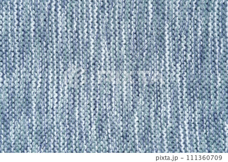 Knitted melange background from woollen yarns in blue and white colors. Abstract grunge overlay texture of a knitted fabric. Knitted melange background from woollen yarns in blue and white colors. Abstract grunge overlay texture of a knitted fabric. 111360709