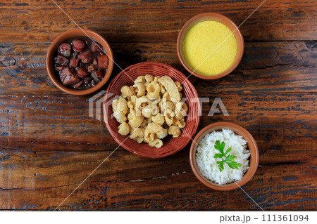 Brazilian feijoada, traditional dish of the Brazilian cuisine, on wooden table 111361094