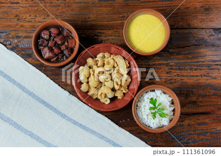Brazilian feijoada, traditional dish of the Brazilian cuisine, on wooden table 111361096