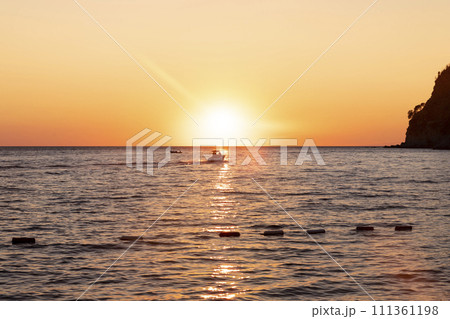 Boat sailing at sea at amazing sunset 111361198