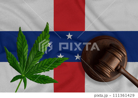 Judicial wooden gavel, fresh hemp leaf and flag of Netherlands Antilles Illegal sale and distribution of marijuana 111361429