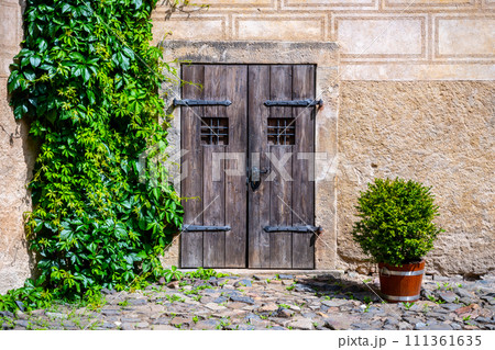 Small vintage wooden castle door. Small vintage wooden castle door. 111361635