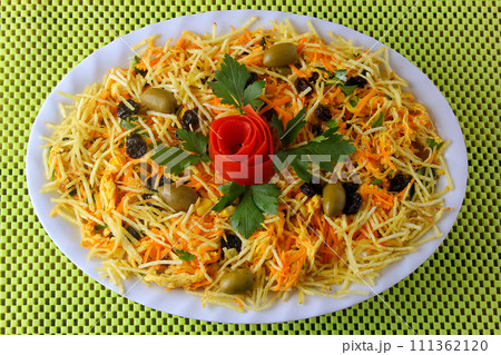 Salpicao is a typical Brazilian salad, made with shredded chicken, raisin, grated carrot, potato sticks and mayonnaise. Salpicao is a typical Brazilian salad, made with shredded chicken, raisin, grated carrot, potato sticks and mayonnaise. 111362120