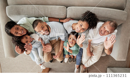 Family, children and wave with a portrait of kids, grandparents and parents sitting on a sofa in the living room of their home from above. Happy, smile and love with a senior man, woman and relatives Family, children and wave with a portrait of kids, grandparents and parents sitting on a sofa in the living room of their home from above. Happy, smile and love with a senior man, woman and relatives 111365231