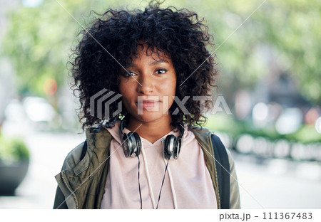 portrait african american woman in city street wearing headphones 111367483