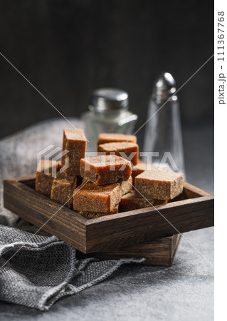 Brown sugar in wooden box on slate background 111367768