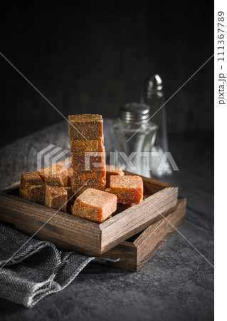 Brown sugar in wooden box on slate background Brown sugar in wooden box on slate background 111367789