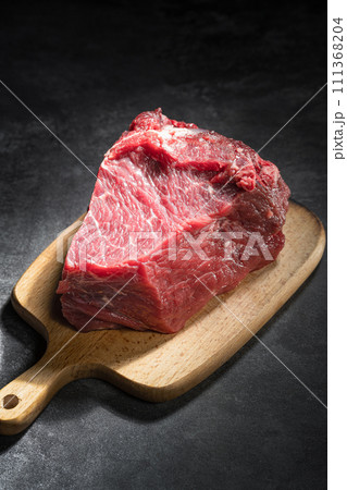 raw beef steak on a black background raw beef steak on a black background 111368204
