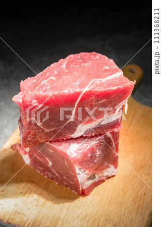 raw beef steak on a black background raw beef steak on a black background 111368211