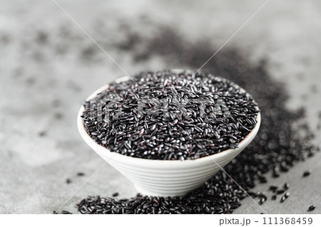 Put black rice in bowl 111368459