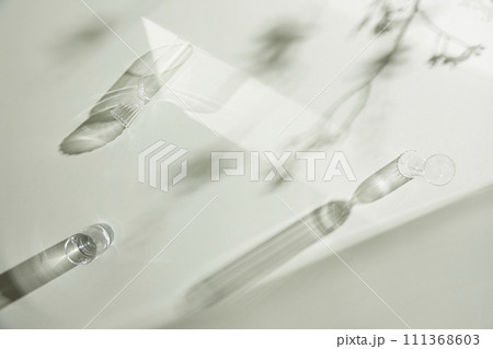 Natural texture of various glass cups on a table with sunlight streaming in. Natural texture of various glass cups on a table with sunlight streaming in. 111368603