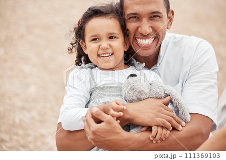 Happy family at beach, father gives kid a hug with smile on her face and laughing with dad. A summer getaway, traveling the world on vacation with family and holidays with friends is a great a break Happy family at beach, father gives kid a hug with smile on her face and laughing with dad. A summer getaway, traveling the world on vacation with family and holidays with friends is a great a break 111369103
