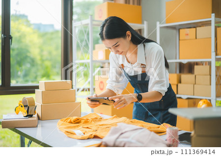Small business owners online are taking pictures of their products and offering them to customers who will place their orders. - online shopping Small business owners online are taking pictures of their products and offering them to customers who will place their orders. - online shopping 111369414