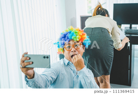boss or supervisor is secretly using a mobile phone to film the buttocks of a female employee at work. Causing young employees to resist because they are uncomfortable and afraid of being sexually boss or supervisor is secretly using a mobile phone to film the buttocks of a female employee at work. Causing young employees to resist because they are uncomfortable and afraid of being sexually 111369415