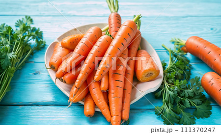 A plate full of carrots on a blue wooden table. 111370247