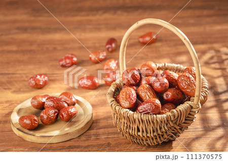 Dates in basket on wooden table 111370575