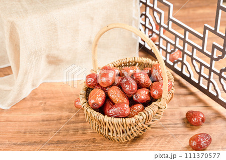 Dates in basket on wooden table Dates in basket on wooden table 111370577