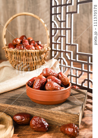 Dates in basket on wooden table 111370578