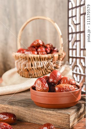Dates in basket on wooden table 111370579