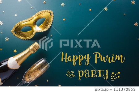 Happy Purim carnival decoration concept made from golden mask star and glitter on dark background. (Happy Purim in Hebrew, jewish holiday celebrate) 111370955